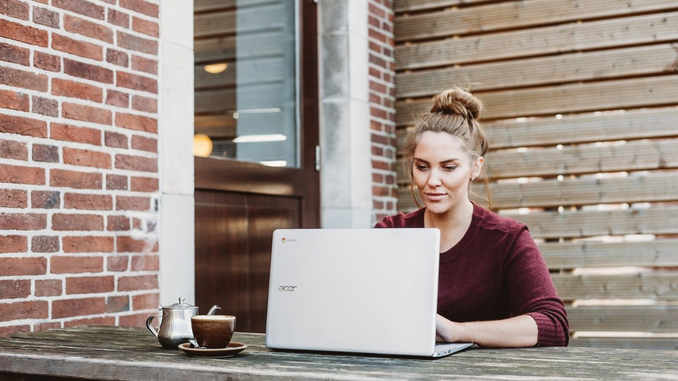 Woman working outside on a laptop