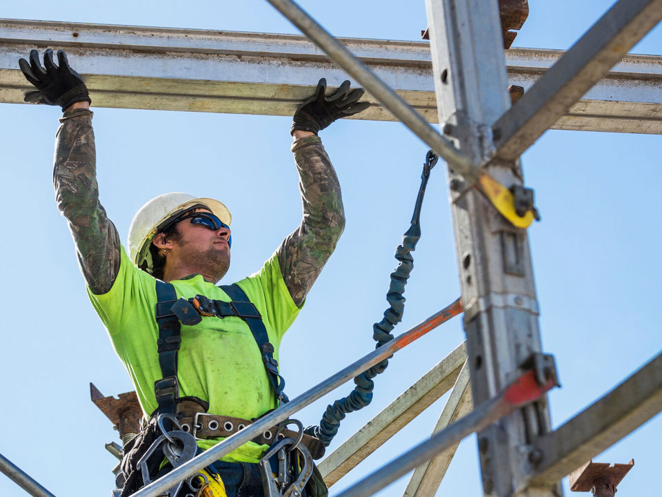 Scaffolding worker wearing high-vis jacket and helmet