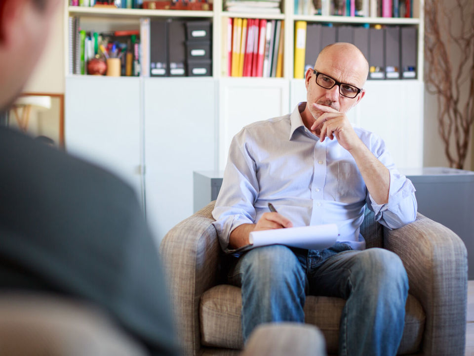 Man talks to another in office