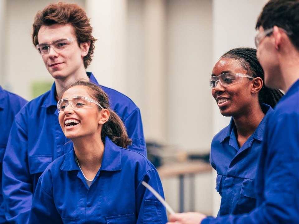 Four young lab workers laughing together