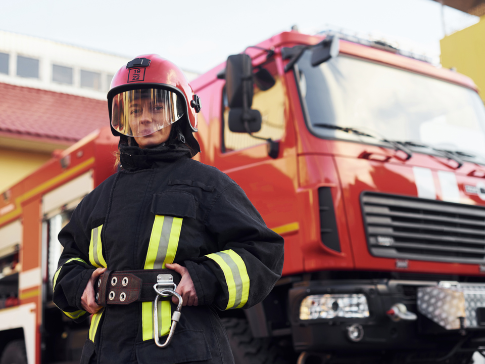 Firefighter standing in front of fire engine